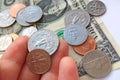 Close up American quarter, dime coins in hand Royalty Free Stock Photo