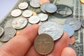 American quarter, dime coins in hand on dollar usa background Royalty Free Stock Photo