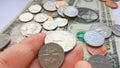 American quarter 25 cents, dime coins in hand on dollar usa background Royalty Free Stock Photo