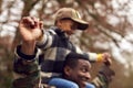 Close Up Of American Soldier Returning Home To Family On Leave Carrying Son Wearing Army Cap Royalty Free Stock Photo