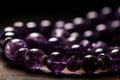 A close-up of amethyst gemstones, necklace or bracelet, with a focus on the unique and deep purple color. Concept luxury and