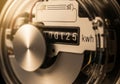 Close-up of an analog electricity meter displaying a reading of 125 Royalty Free Stock Photo