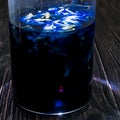 Close-up of anchan flower herbal blue tea Clitoria Ternatea in a glass beaker Royalty Free Stock Photo