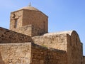 close up of the ancient church of Ayia Kyriaki Chrysopolitissa in paphos cyprus showing the basilica shaped structure and tower