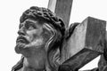 Close Up An Ancient Statue Of Jesus Christ With Cross. Selective Focus On Eyes. Free Copy Space. Horizontal Image