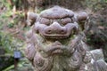 Close-up of ancient stone lion-dog sculpture next to Yoro waterfall. Gifu Royalty Free Stock Photo