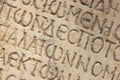 Close up of an ancient text carved on marble.