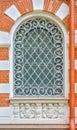 Close-up of ancient vintage arch window with cast iron white lattice, pattern Royalty Free Stock Photo