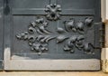 Close-up of ancient vintage metal door with cast iron floral deorative ornament Royalty Free Stock Photo