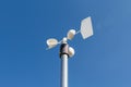 Close up of the anemometer on top of the pole against the clear blue sky. Royalty Free Stock Photo