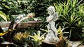 Close-up of an angel figurine. Child stone statue. Abandoned Garden Angel Royalty Free Stock Photo