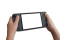Close-up angled view of hands holding a handheld gaming console from the left side