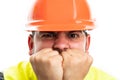 Close-up of angry builder man covering mouth with fists Royalty Free Stock Photo