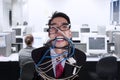 Close-up angry businessman tied in rope and cable