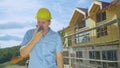 CLOSE UP: Angry contractor shouts at his co-worker over the walkie talkie. Royalty Free Stock Photo