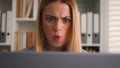 Close up angry upset Caucasian woman user using laptop in home office frustrated mad confused shocked computer problem