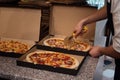 Close up of anonimous pizza chef slicing appetising pizza