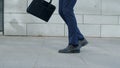 Businessman feet dancing on street alone. Employee holding briefcase in hand Royalty Free Stock Photo