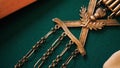 Close-up of antique brooch. Stock footage. Antique bronze brooch with chains and inscriptions. Old brooch with its own