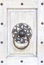 Close up antique Chinese traditional brass door knocker on white texture door background. Asia architecture vintage doorknob. Royalty Free Stock Photo