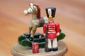 Close up of an antique Christmas musical box with a wooden toy soldier and rocking horse Royalty Free Stock Photo