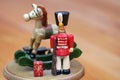 Close up of an antique Christmas musical box with a wooden toy soldier and rocking horse Royalty Free Stock Photo