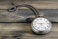 Close up of an antique pocket watch on an antique wooden table Royalty Free Stock Photo