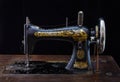 Close up of antique sewing machine Singer on black background.