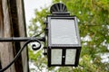 Close-up of an antique, wrought iron electrical wall lantern.