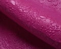 A close up of anulated magenta plastic with a small and py texture. Trendy color of 2023 Viva Magenta.. AI generation