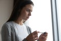 Close up anxious unhappy young woman holding plastic pregnancy test Royalty Free Stock Photo