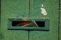 Close-up of aperture for mailing in old wooden door