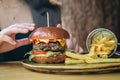 Close-up, appetizing burger and french fries in a cafe. Royalty Free Stock Photo