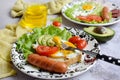 Close-up of appetizing scrambled eggs with sausages and avocado on a beautiful plate on a gray background. Delicious Royalty Free Stock Photo