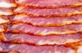 Close-up of appetizing slices of smoked bacon. Royalty Free Stock Photo