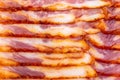 Close-up of appetizing slices of smoked bacon.