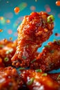 Close up Appetizing Spicy Buffalo Wings with Sauce Splashes and Spring Onion on Blue Background Royalty Free Stock Photo