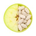 Close up of apple and pills isolated Royalty Free Stock Photo
