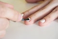 Close-up of applying white nail polish with a brush. Manicure at home. Poor-quality manicure Royalty Free Stock Photo