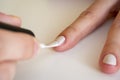 Close-up of applying white nail polish with a brush. Manicure at home. Poor-quality manicure Royalty Free Stock Photo