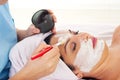 Close up of applying woman's facial mask