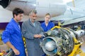 close up apprentices during inspection aircraft mechanism