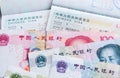 Close up of approved China travel Visa and Chinese currency Yuan banknotes money