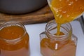 Close up of apricot jam being poured into a glass jar Royalty Free Stock Photo