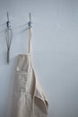 Apron and whisker hanging on hook Royalty Free Stock Photo