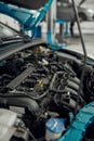 For fresh start. Close up of a car with open hood under under maintenance in auto repair shop