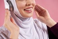 Close up. Arab woman in hijab listens to music