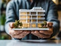Close-up of an architect\'s hands holding a small model of a building Royalty Free Stock Photo