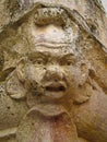A close up of a stone Grotesque carved face