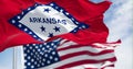 Close-up of Arkansas state flag waving with the American flag on a clear day